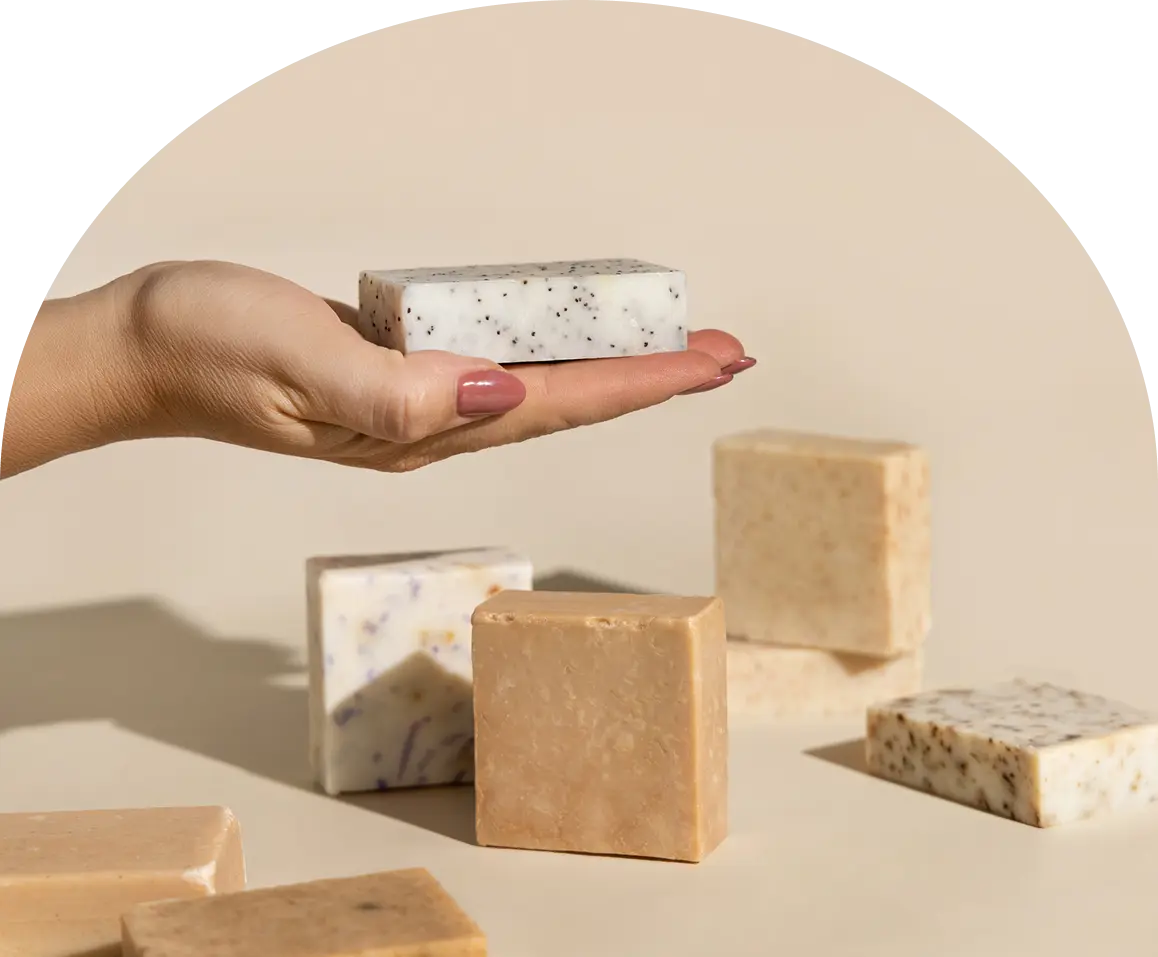 Hand holding speckled soap bar
