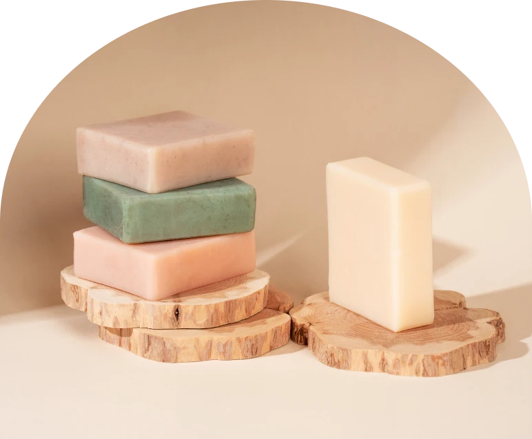 Natural soap bars on rustic wooden coasters
